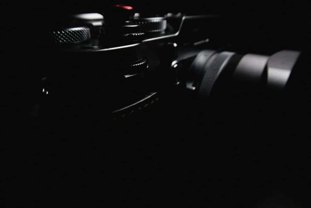 Black camera on black background.