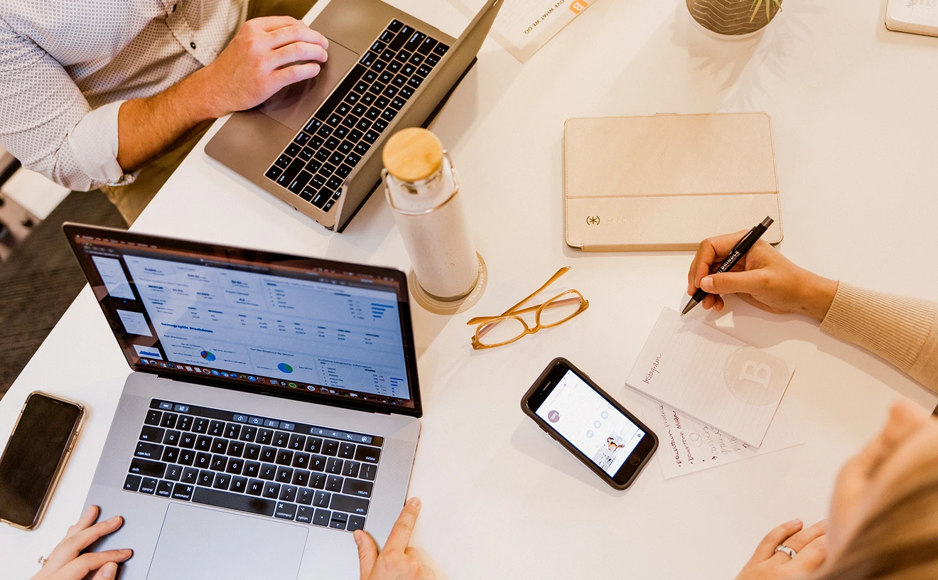 Office meeting with laptops and notes